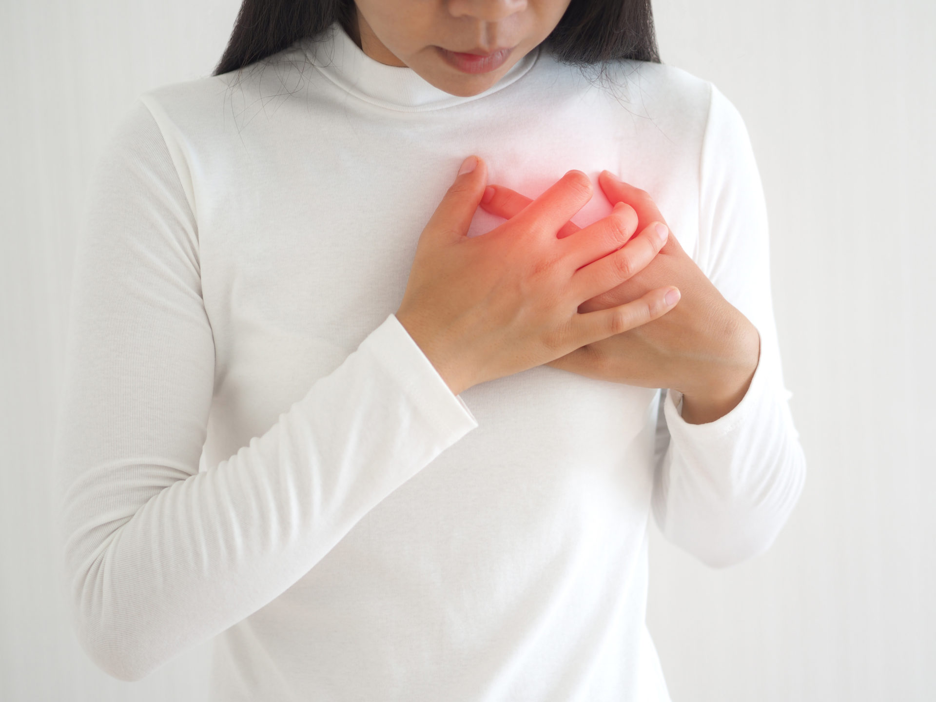 heart failure and heart attack in woman and she press her chest symptom of pain and suffering cause of arrhythmia and bradycardia use for medicine product and health care concept on white background.